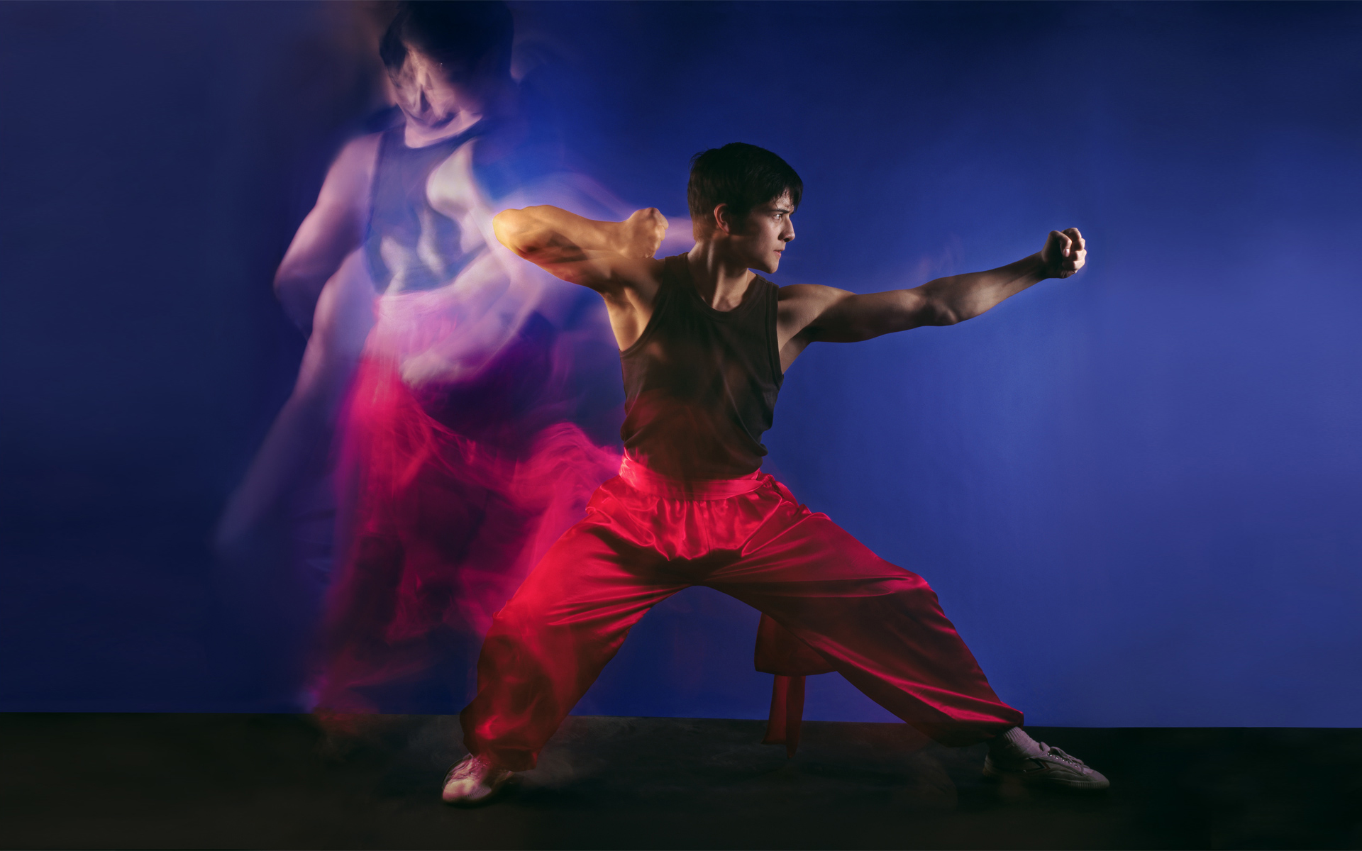 photo shoot kung fu actor in red front of blue backdrop photo shoot London